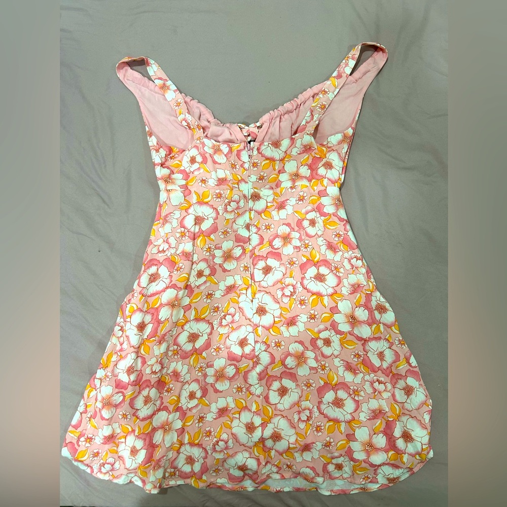 Copper key romper. Floral: orange, pink, white.